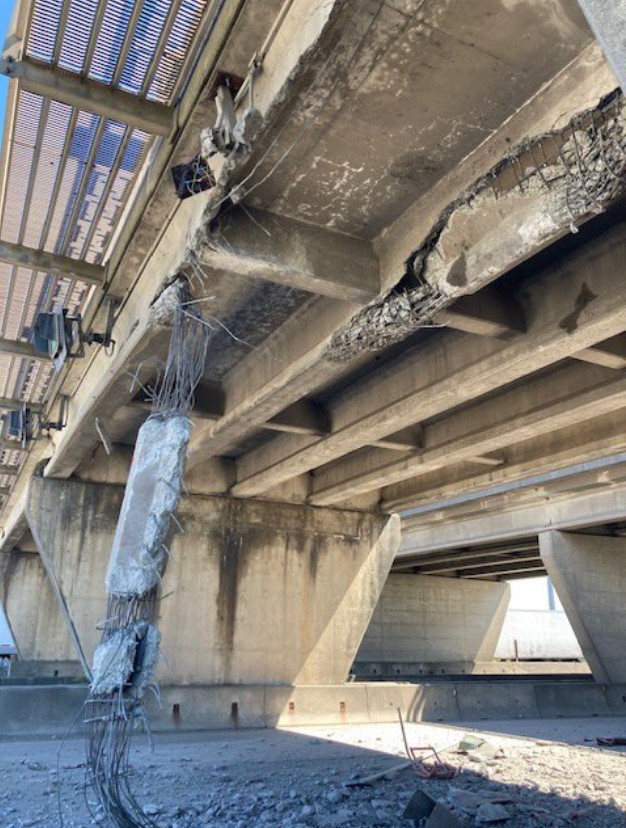 an overpass in delta with part of it falling off after it was struck by a vehicle