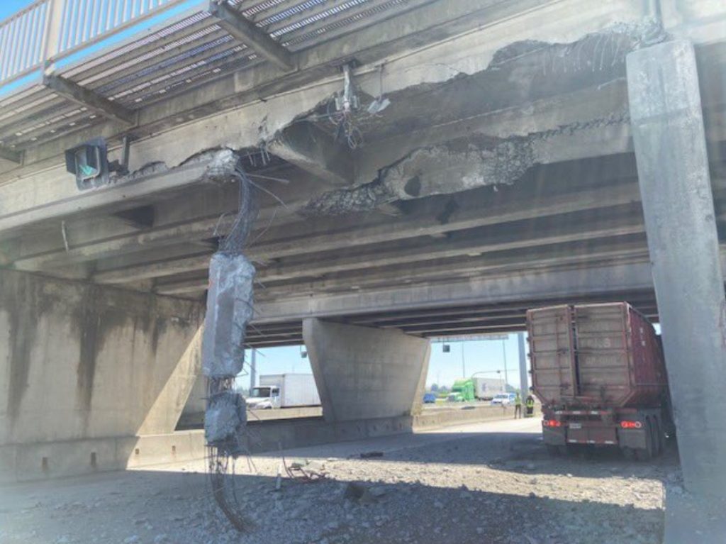 an overpass in delta with part of it falling off after it was struck by a vehicle