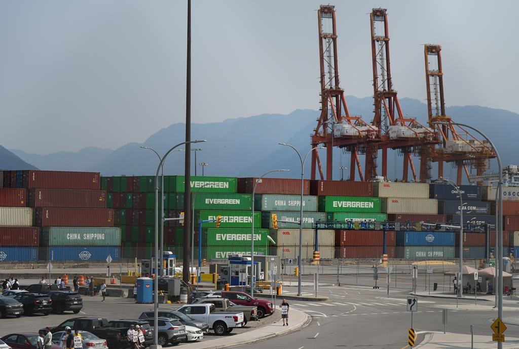 A port with ships, containers, and vehicles.