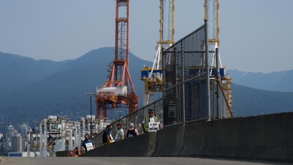 Striking International Longshore and Warehouse Union Canada workers picket at a port entrance in Vancouver, B.C., Tuesday, July 4, 2023.