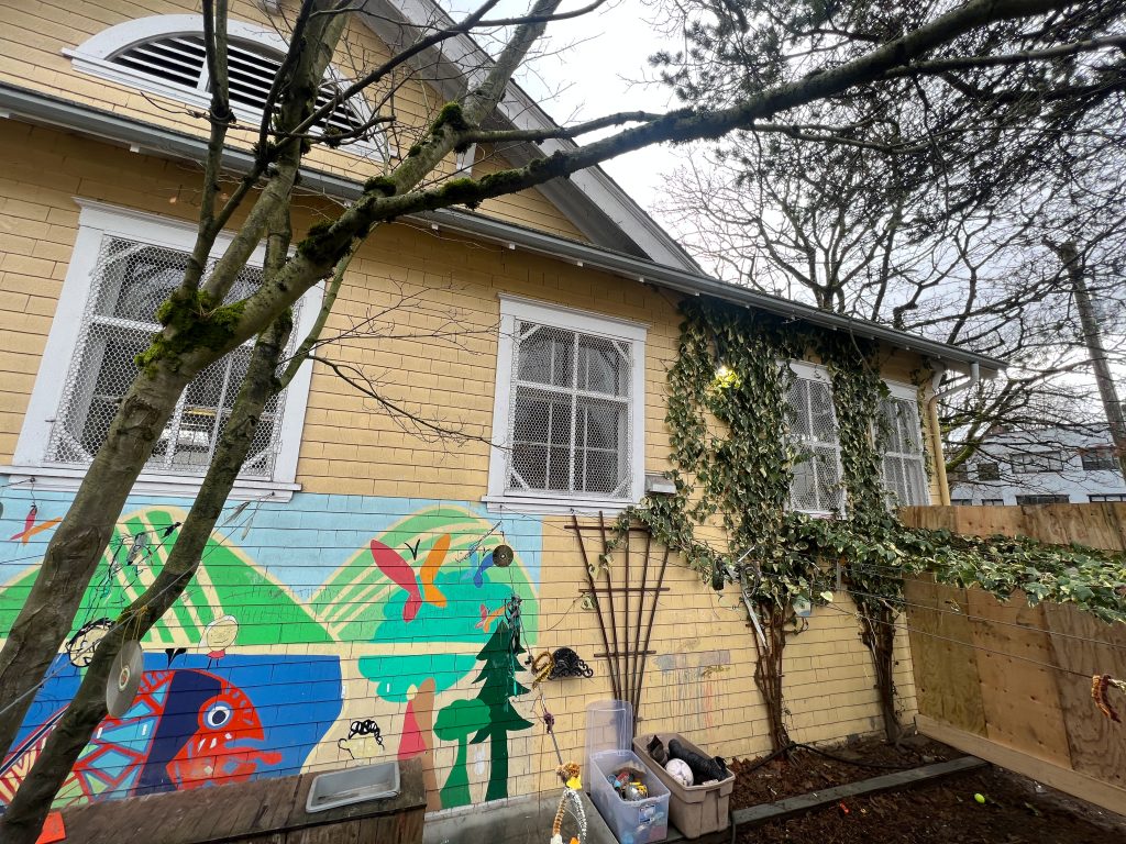 the outside of a historic yellow builiding will serve as a centre to teach children the squamish language and help preserve cultural values