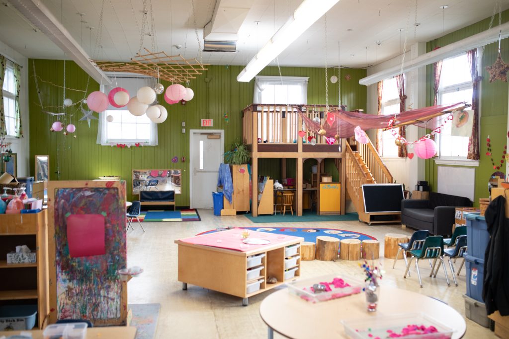 the inside of a small building decorated with balloons and small tables will serve as a centre to teach children the squamish language and help preserve cultural values