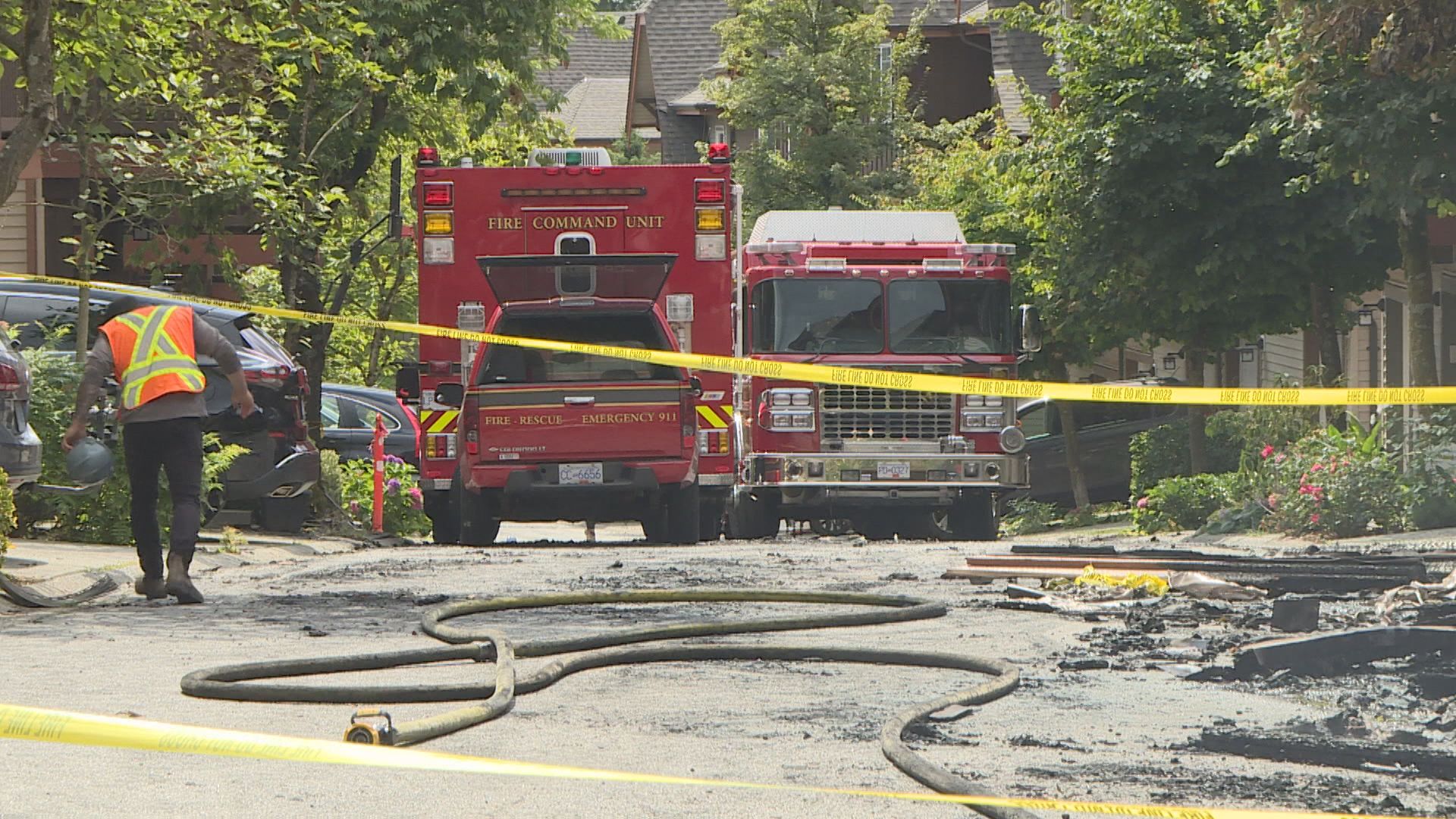 Firetrucks on a road in Port Moody after a fire.