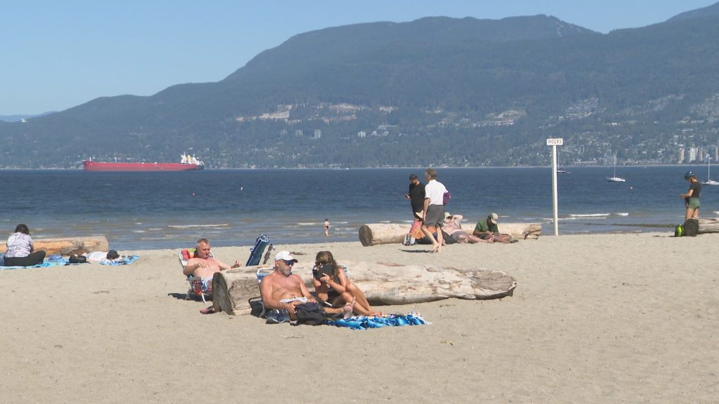 People on a beach in Vancouver during hot weather