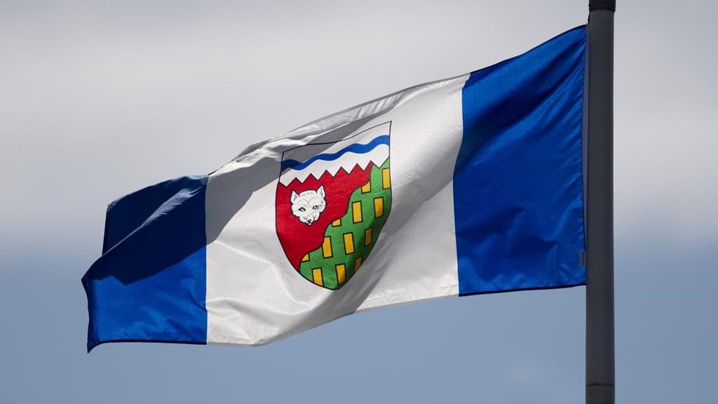 Transportation authorities in the Northwest Territories say the highway out of a community near the Alberta boundary that's being evacuated due to wildfires has now closed. The Northwest Territories provincial flag flies on a flag pole in Ottawa on June 30, 2020.