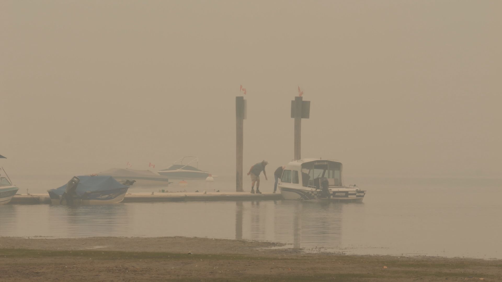 Boats are seen on Little Shuswap Lake in Chase, B.C. as the air is filled with smoke.