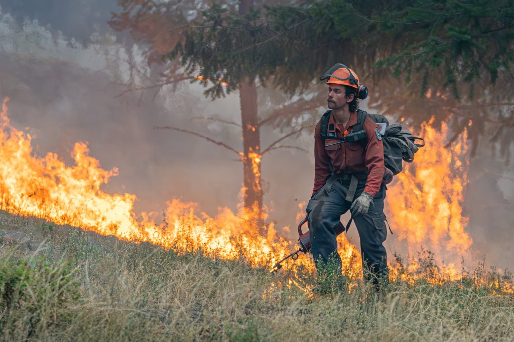 A firefighter works on the McDougall Creek Wildfire in West Kelowna in 2023.