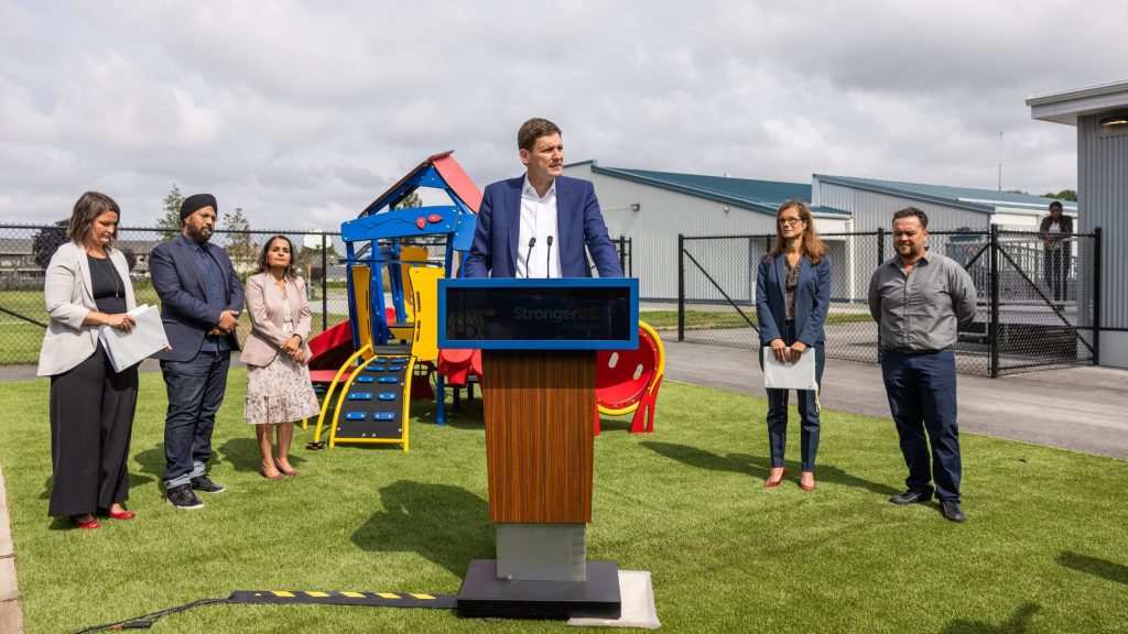 B.C. Premier David Eby speaks outside of a school