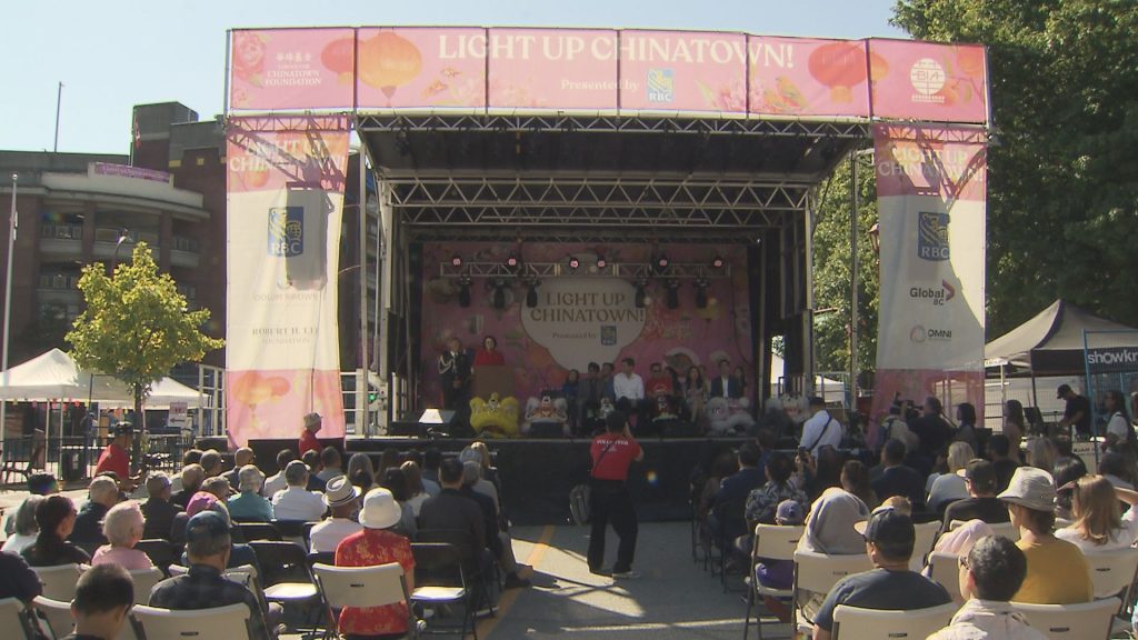 A stage is seen with a crowd in front in Vancouver's Chinatown