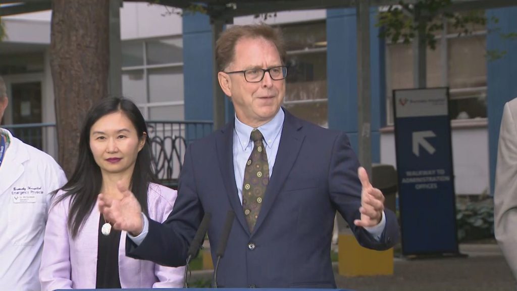 Adrian Dix in front of Burnaby Hospital.
