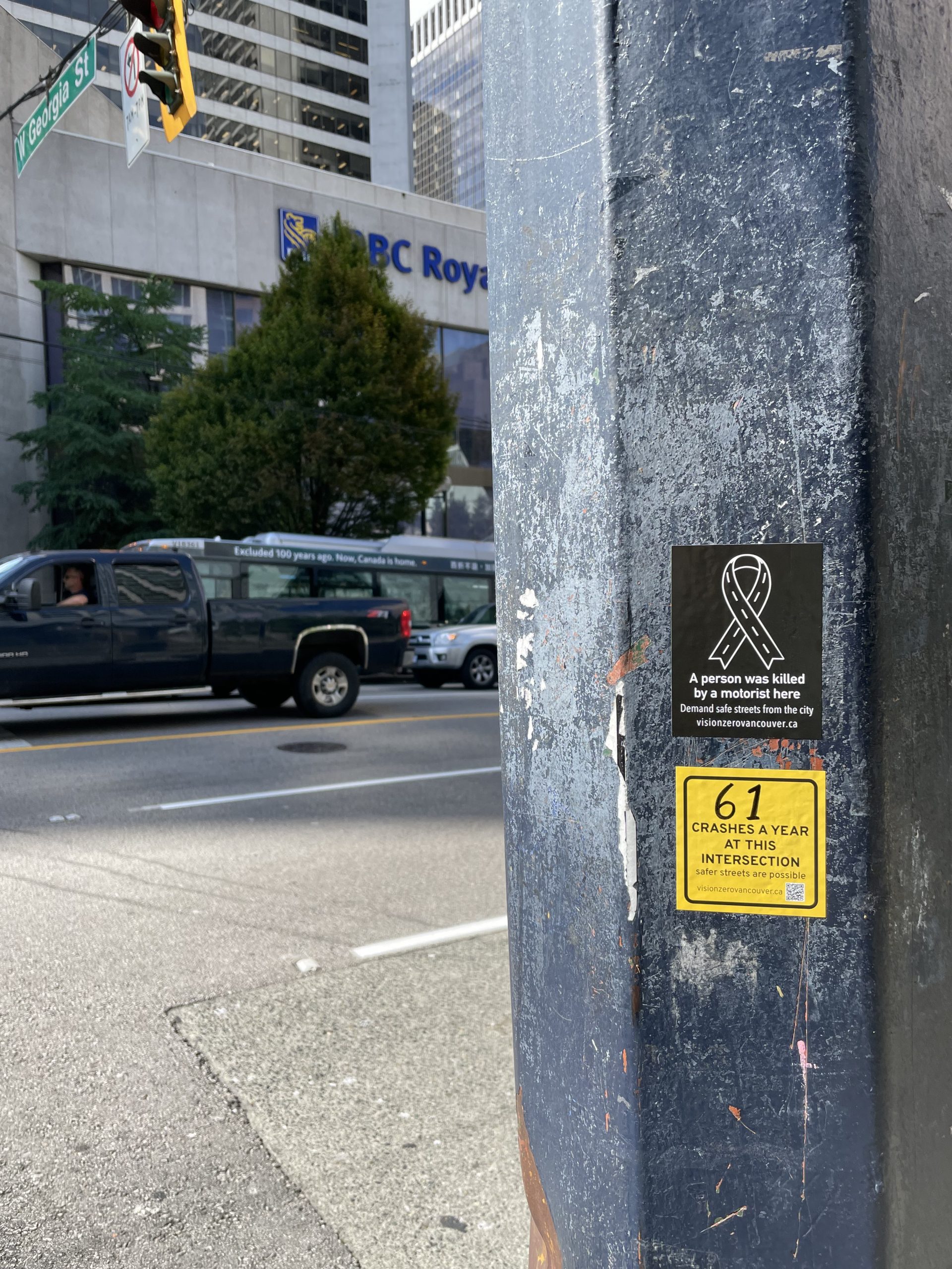 A sticker posted at the intersection of Georgia Street and Burrard Street in Vancouver