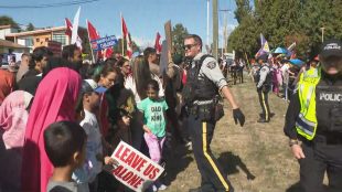 Protestors and counter protestors gather outside the Surrey Teachers' Association building in Surrey