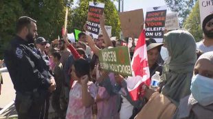 Protestors and counter protestors gather outside the Surrey Teachers' Association building in Surrey