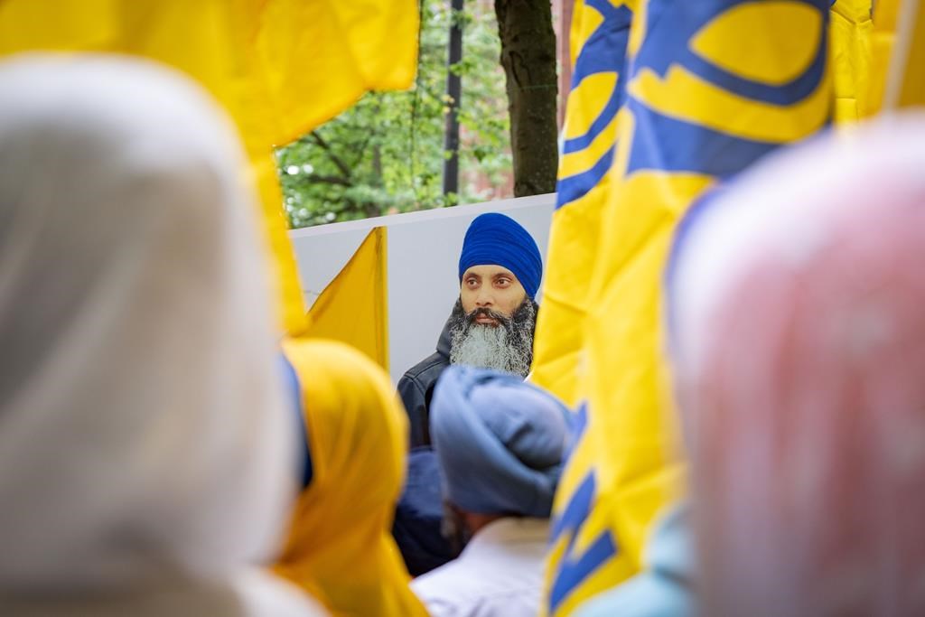 An image of Hardeep Singh Nijjar is seen on a poster as people gather outside the Indian Consulatein Vancouver, B.C., during a protest on Saturday, June 24, 2023. Nijjar is being remembered by family and supporters as a generous community activist. THE CANADIAN PRESS/Ethan Cairns