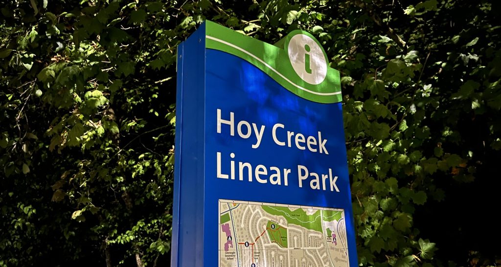 A sign for Hoy Creek Linear Park with a map