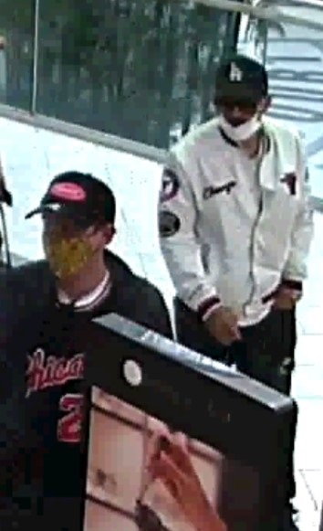 Two suspects wanted in connection with a reported theft and assault at Metrotown Mall in Burnaby on Sept. 17. One is wearing a dark-coloured baseball cap with a white LA Dodgers logo on the front, a white medical mask, and glasses. The other is wearing a dark baseball cap with a red logo on it, a grey jacket, dark shirt with "Chicago" and "23" on the front, blue jeans, and black shoes with white soles. They were carrying a black backpack at the time of the incident.