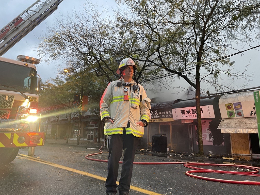 Assistant Chief Keith Stewart stands at the site of a massive fire overnight in Vancouver's Kerrisdale neighbourhood that has damaged multiple buildings, affecting businesses. (Sonia Aslam / CityNews)
