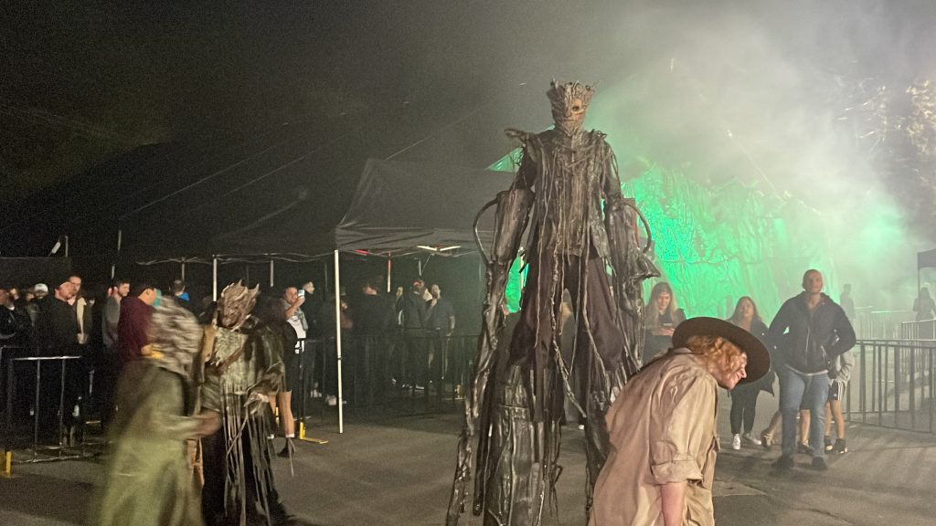 a creature on stilts frightens folks at the PNE during a Fright Night