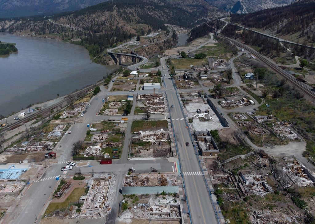 Debris covered houses and businesses that were destroyed by the 2021 wildfire are seen from this aerial shot in Lytton, B.C., on June 15, 2022.