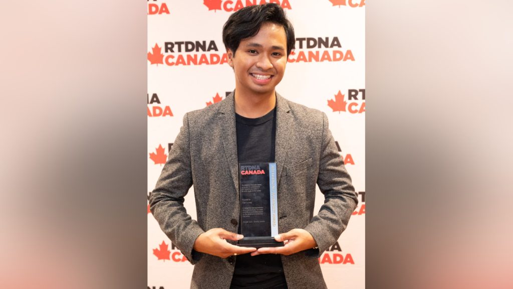 CityNews Vancouver VJ Kier Junos, the 2023 RTDNA Canada recipient of the Emerging Journalist Award, holds up the award in Toronto