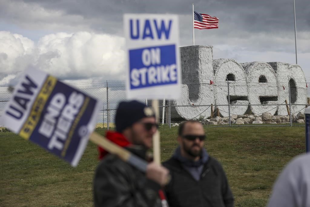 File - Striking UAW workers picket at the Jeep Assembly Plant on Oct. 9, 2023 in Toledo, Ohio. The UAW contends that the furloughs by Detroit's three automakers were not necessary and are being done in an effort to push members to accept less in contract negotiations.