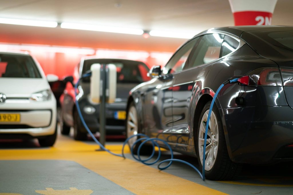 An electric vehicle is shown at a charging station