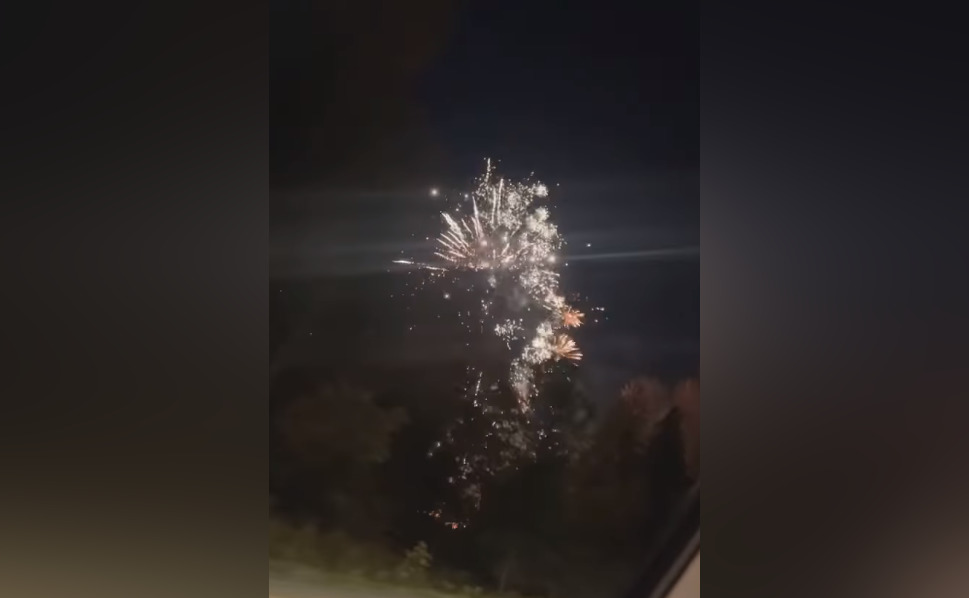 Fireworks are seen from near a crash site after a truck towing the pyrotechnics was hit by a semi truck on Highway 1 west of Hope