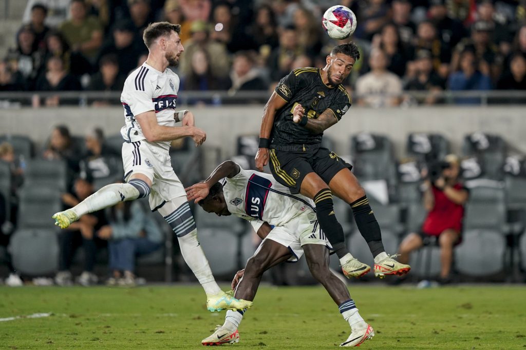 Los Angeles FC forward Denis Bouanga, top right, and Vancouver Whitecaps midfielder Richie Laryea, bottom, and defender Tristan Blackmon vie for the ball during the second half of an MLS playoff soccer match