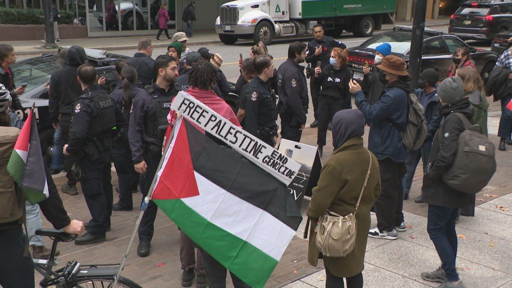 Protestors stage a "die-in" at the Vancouver offices of the Israel-based shipping company ZIM