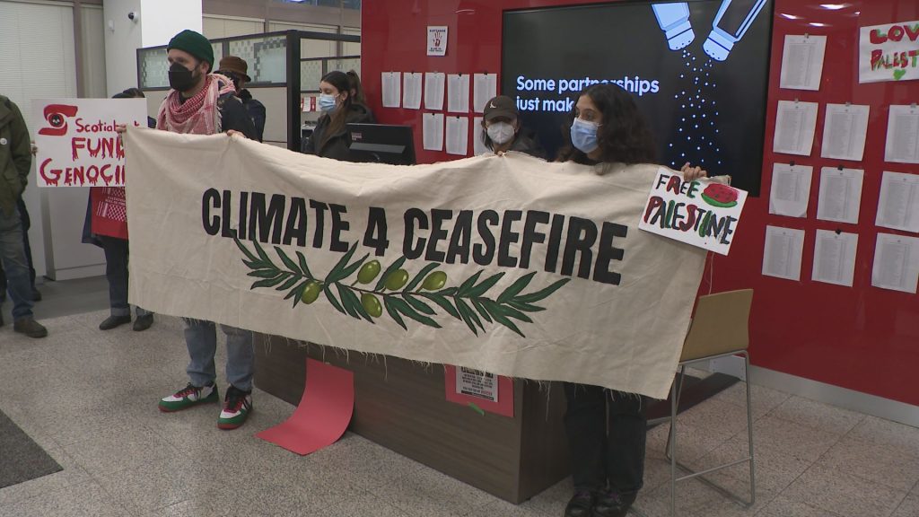 Protestors stage a "die-in" at the Vancouver offices of the Israel-based shipping company ZIM