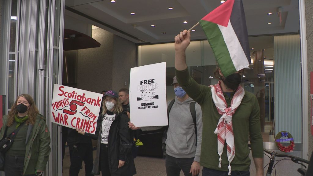 Protestors stage a "die-in" at the Vancouver offices of the Israel-based shipping company ZIM