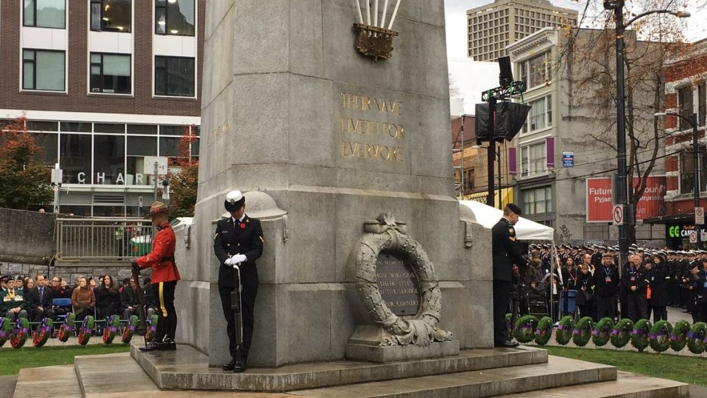 Military members stand in Victoria Square as part of a Remembrance Day ceremony in Vancouver