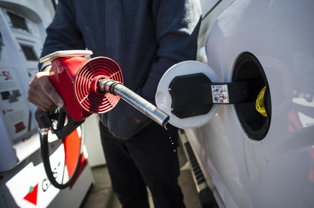 A man prepares to pump gas in Toronto, on April 1, 2019.