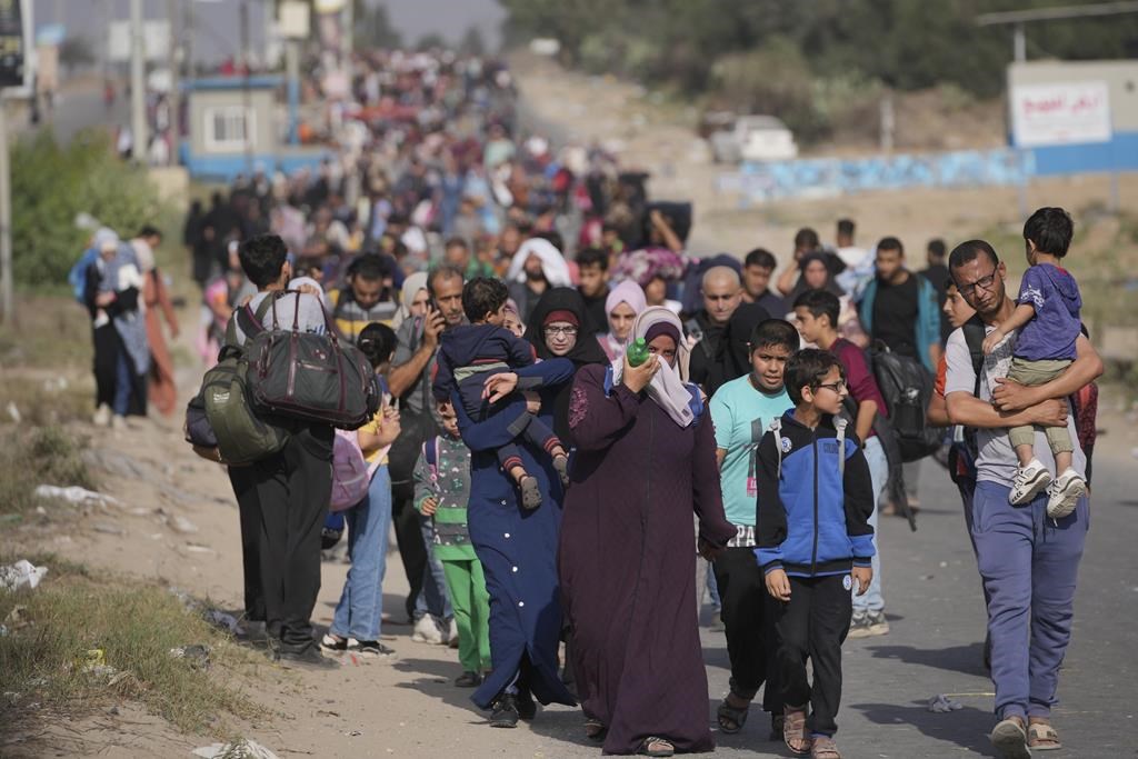 Palestinians flee to the southern Gaza Strip on Salah al-Din Street in Bureij, Gaza Strip, on Wednesday, November 8, 2023. A Canadian woman who evacuated Gaza with the first cohort of citizens this week says she feels relief she has escaped the brutal Israel-Hamas war with her two kids and is soon flying to her home in Mississauga, Ont.