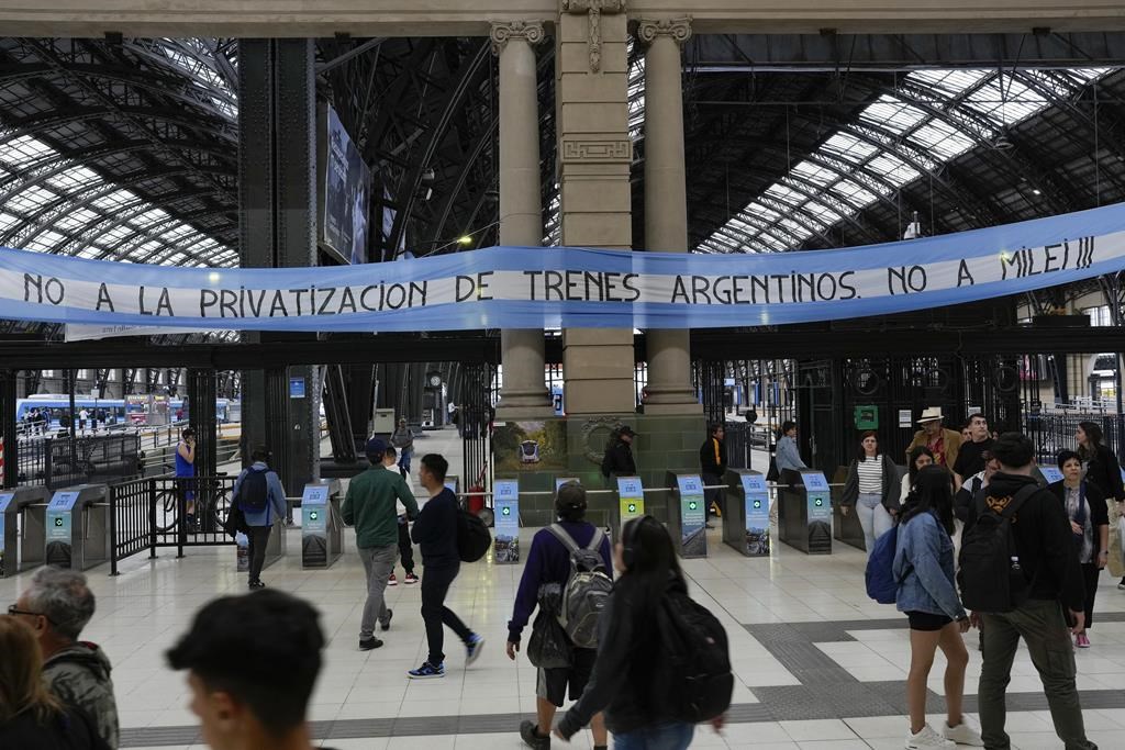 A banner with a message reading in Spanish: " No to the privatization of Argentine trains, no to Milei" hangs at the Retiro train station in Buenos Aires, Argentina, Saturday, Nov. 18, 2023.