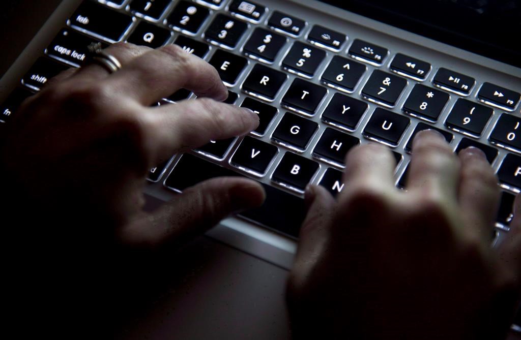 Police in Prince George, B.C., are reporting that a 12-year-old boy died by suicide in October after falling victim to online sextortion. A person uses a keyboard in North Vancouver, B.C., Wednesday, Dec. 19, 2012.