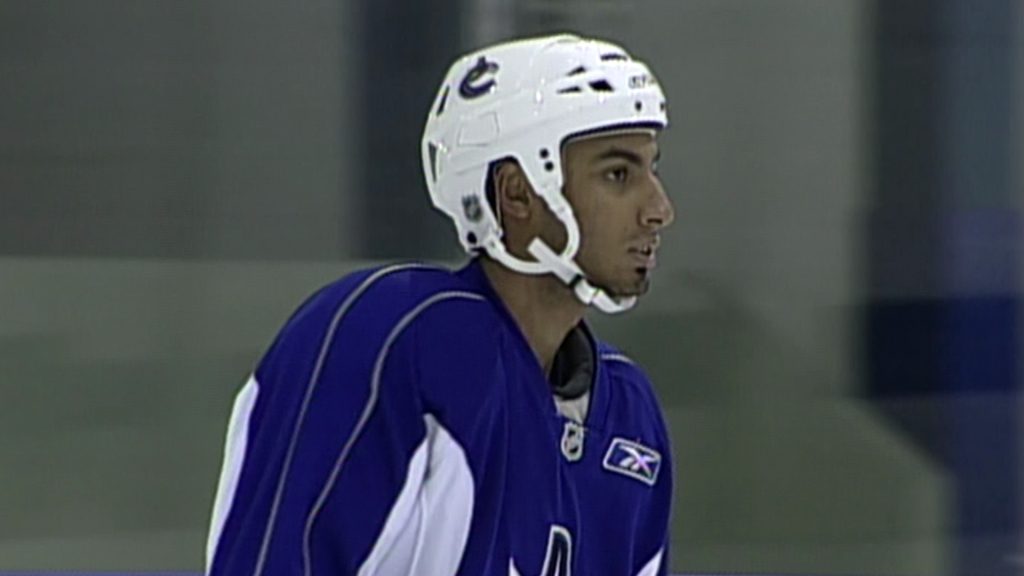 Prabhraj Rai skates on ice in a Canucks uniform