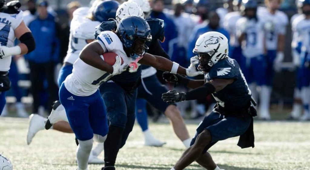 Montreal Carabins receiver Iraghi Uganda pushes past UBC Thunderbirds defensive back Ben Sangmuah to score a touchdown during first quarter action at the Canadian University Football Championship Vanier Cup.