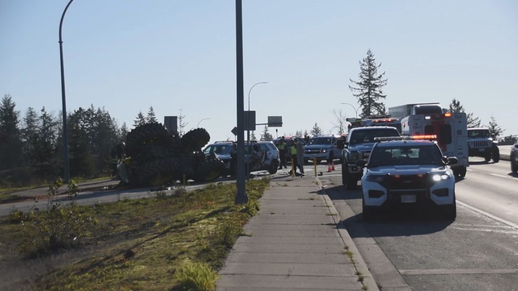 A tractor travelling on Highway 1 hit a police cruiser on Nov. 25, 2023, causing the tractor to roll over, according to Surrey RCMP