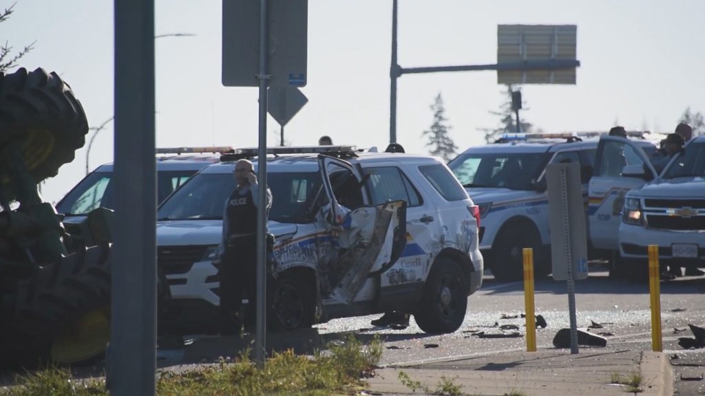 A tractor travelling on Highway 1 hit a police cruiser on Nov. 25, 2023, causing the tractor to roll over, according to Surrey RCMP