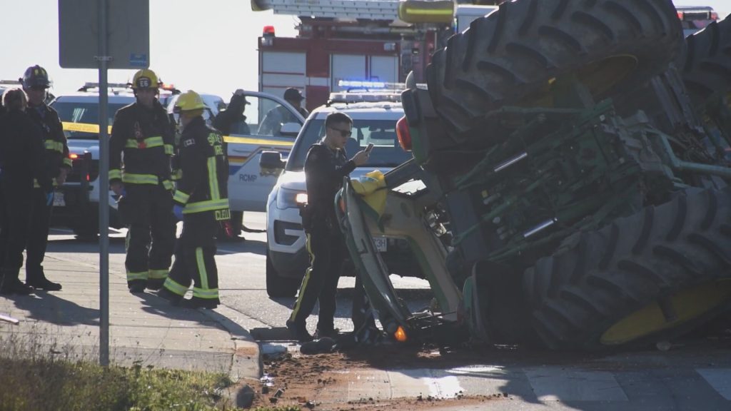 A tractor travelling on Highway 1 hit a police cruiser on Nov. 25, 2023, causing the tractor to roll over, according to Surrey RCMP