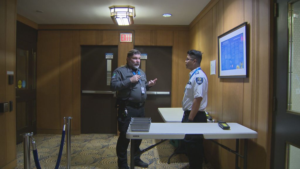 Security screens an individual at Vancouver City Hall