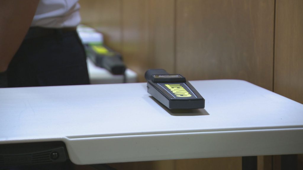 Security screens an individual at Vancouver City Hall