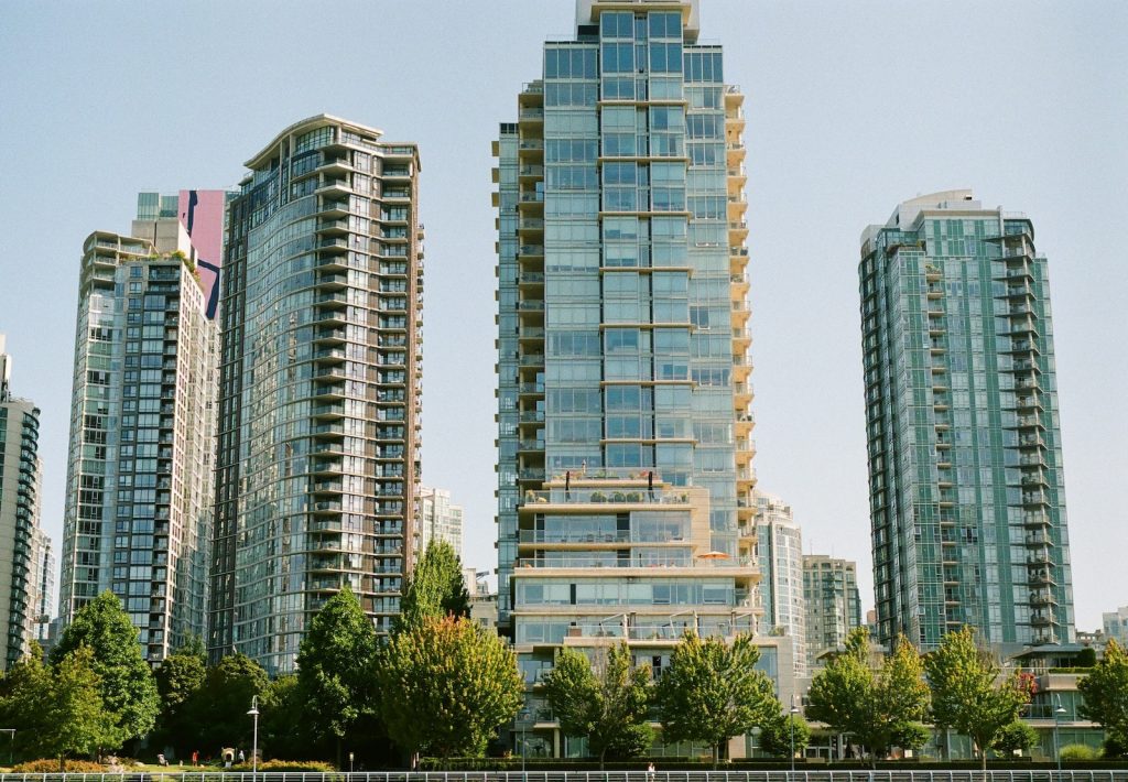 Green trees near high rise buildings during daytime in Vancouver, BC.