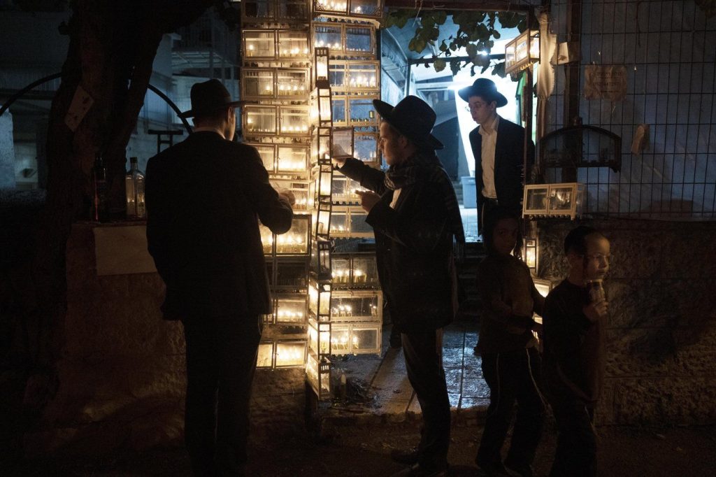 Ultra-Orthodox Jewish seminary students light candles on the fifth night of Hanukkah in the Mea Shearim neighbourhood of Jerusalem, Thursday, Dec. 22, 2022