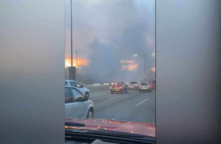 A fire in central Burnaby cloaks Highway 1 in smoke on Dec. 7, 2023.