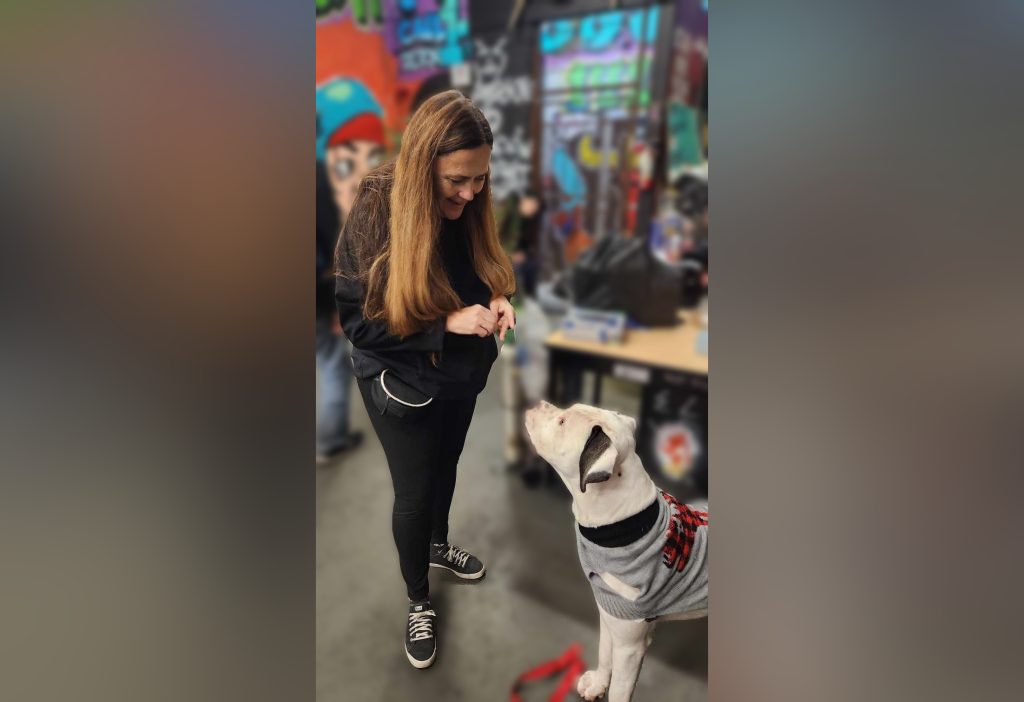 Dog trainer Kim Monteith works with Domino the dog at an Overdose Prevention Society site