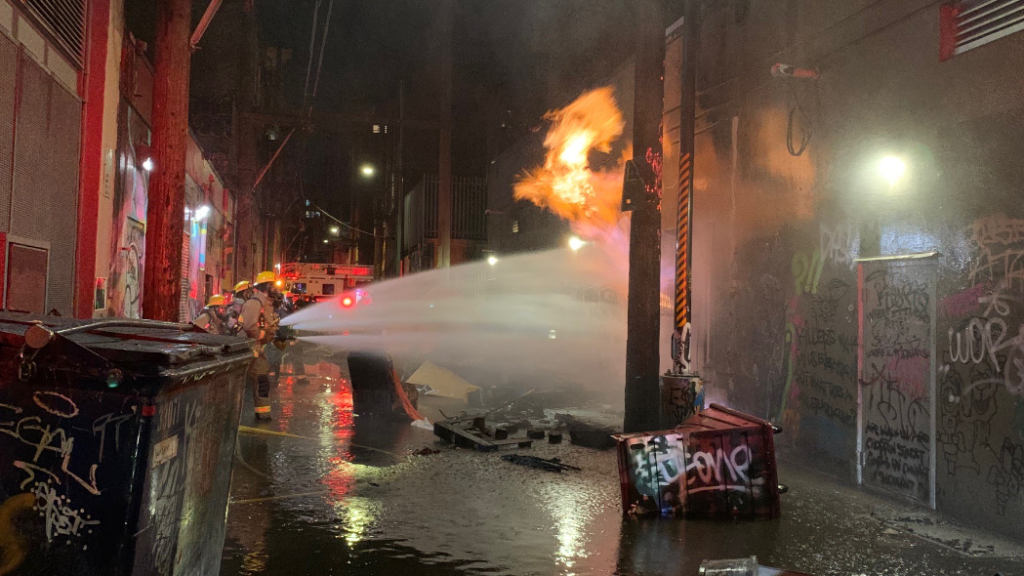 Vancouver firefighters battle flames in an alleyway