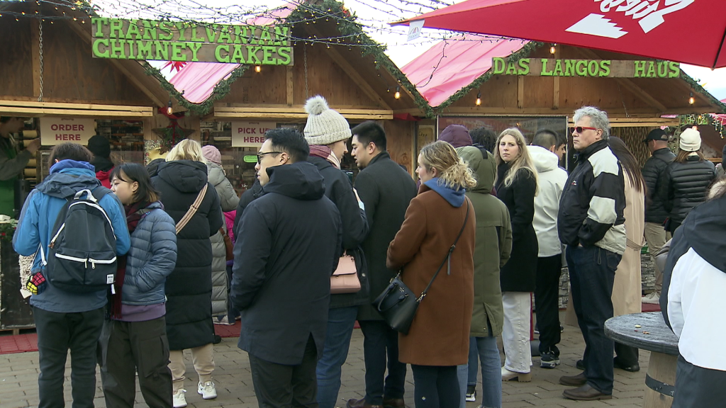 Patrons line up for chimney cakes at the Vancouver Christmas Market on Dec. 23, 2023.