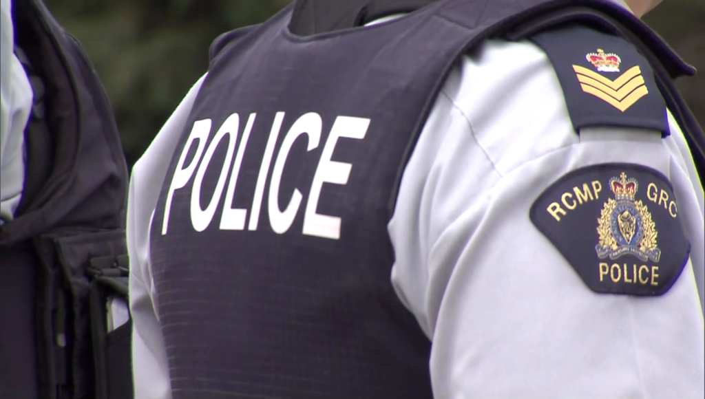 The word POLICE on the back of a Surrey RCMP officer's vest